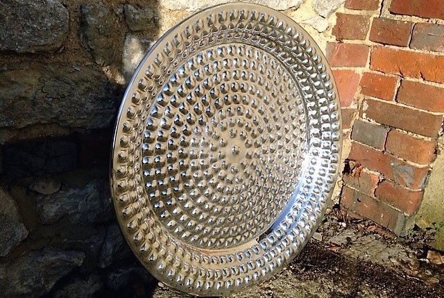 An antique tray restored using metal polishing.