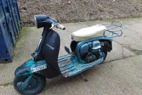 Photo of a vintage scooter with parts in need of rechroming